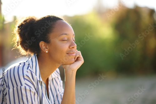Black relaxed woman resting in a park