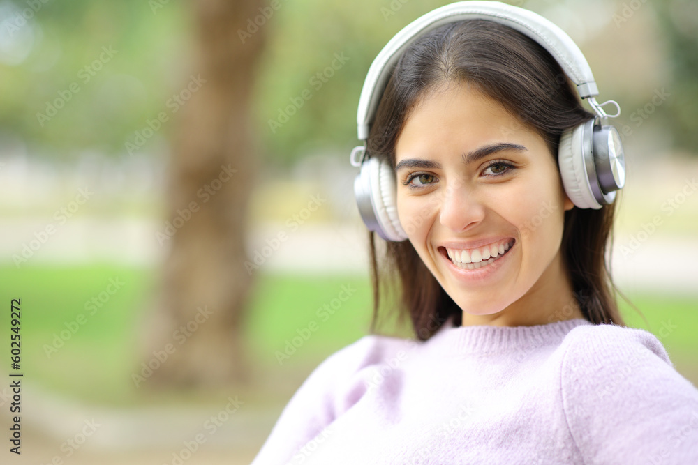 Happy woman with headphone looks at you Happy woman with headphone looks at you
