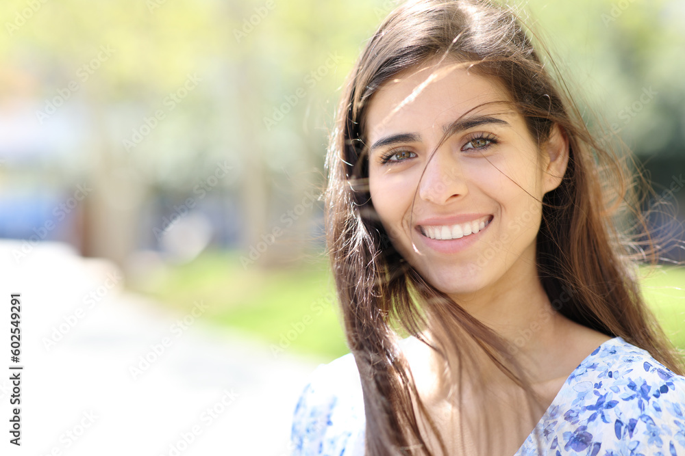 Happy woman with tousled hair looks at you Happy woman with tousled hair looks at you