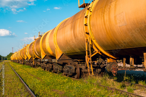 Railroad train of tanker cars transporting crude oil on the tracks