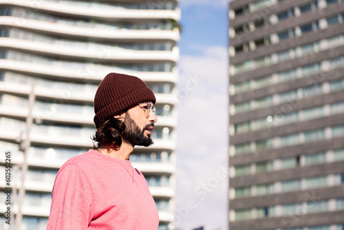 modern young man exploring city on sunny day, concept of street style and urban lifestyle, copy space for text © Raul Mellado