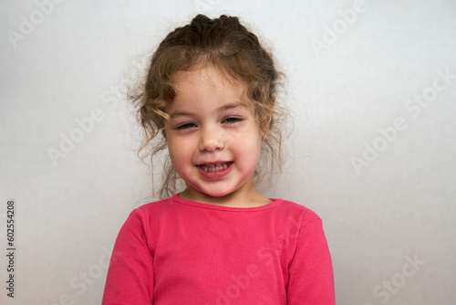 Cute little girl portrait on a grey background
