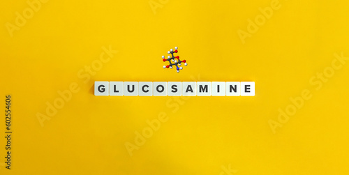 Glucosamine Molecule and Ball and stick model. Word on Letter Tiles on Yellow Background. Minimal Aesthetics. photo