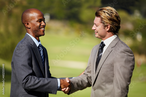 Happy business men, shaking hands and outdoor for agreement, welcome or teamwork in diversity. Businessman, hand shake and smile in collaboration, deal or excited for partnership meeting or thank you