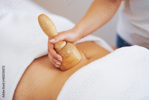 Woman at massage therapy with wooden tools photo