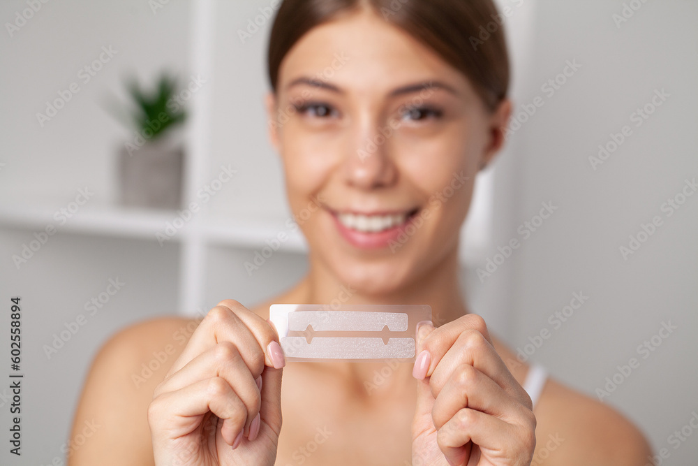 Teeth Whitening, Beautiful Smiling Woman Holding Whitening Strip. Teeth Whitening, Beautiful Smiling Woman Holding Whitening Strip.