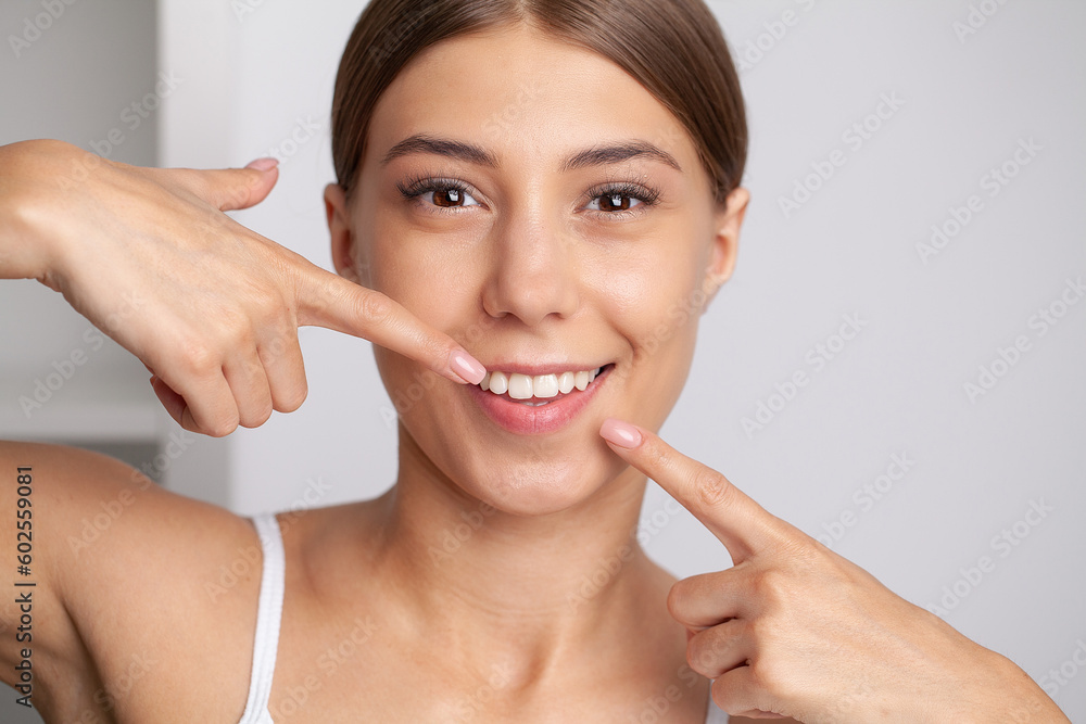 Woman with strong white teeth looking at camera and smiling Woman with strong white teeth looking at camera and smiling