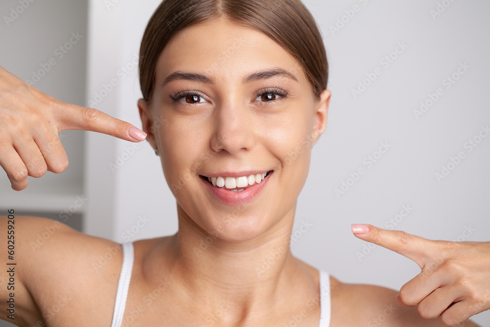 Woman with strong white teeth looking at camera and smiling Woman with strong white teeth looking at camera and smiling