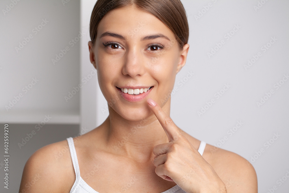 Woman with strong white teeth looking at camera and smiling Woman with strong white teeth looking at camera and smiling