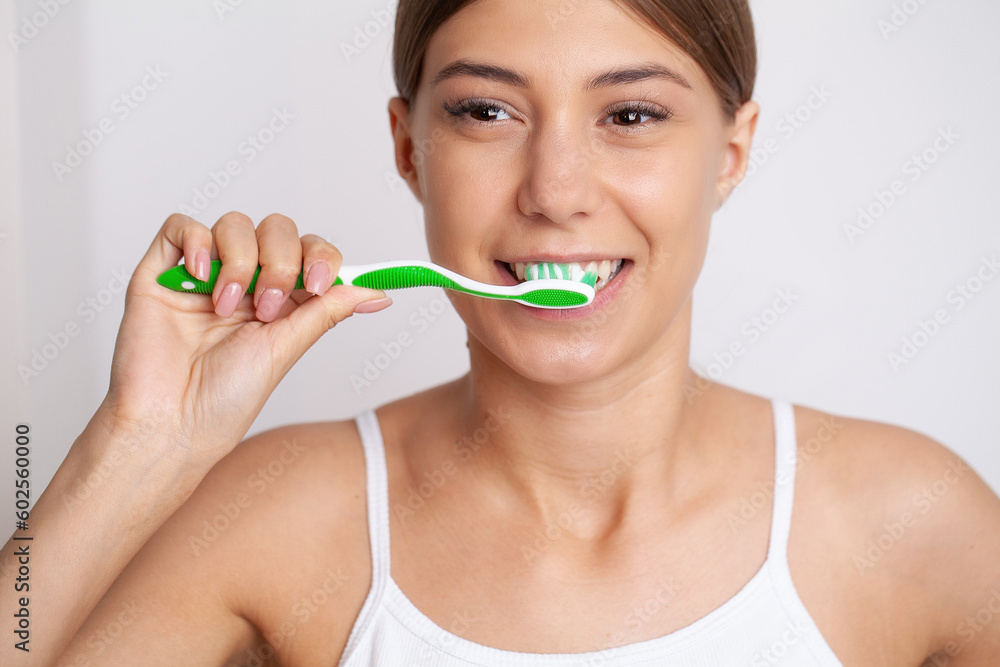 Portrait of beautiful young woman brushing teeth Portrait of beautiful young woman brushing teeth