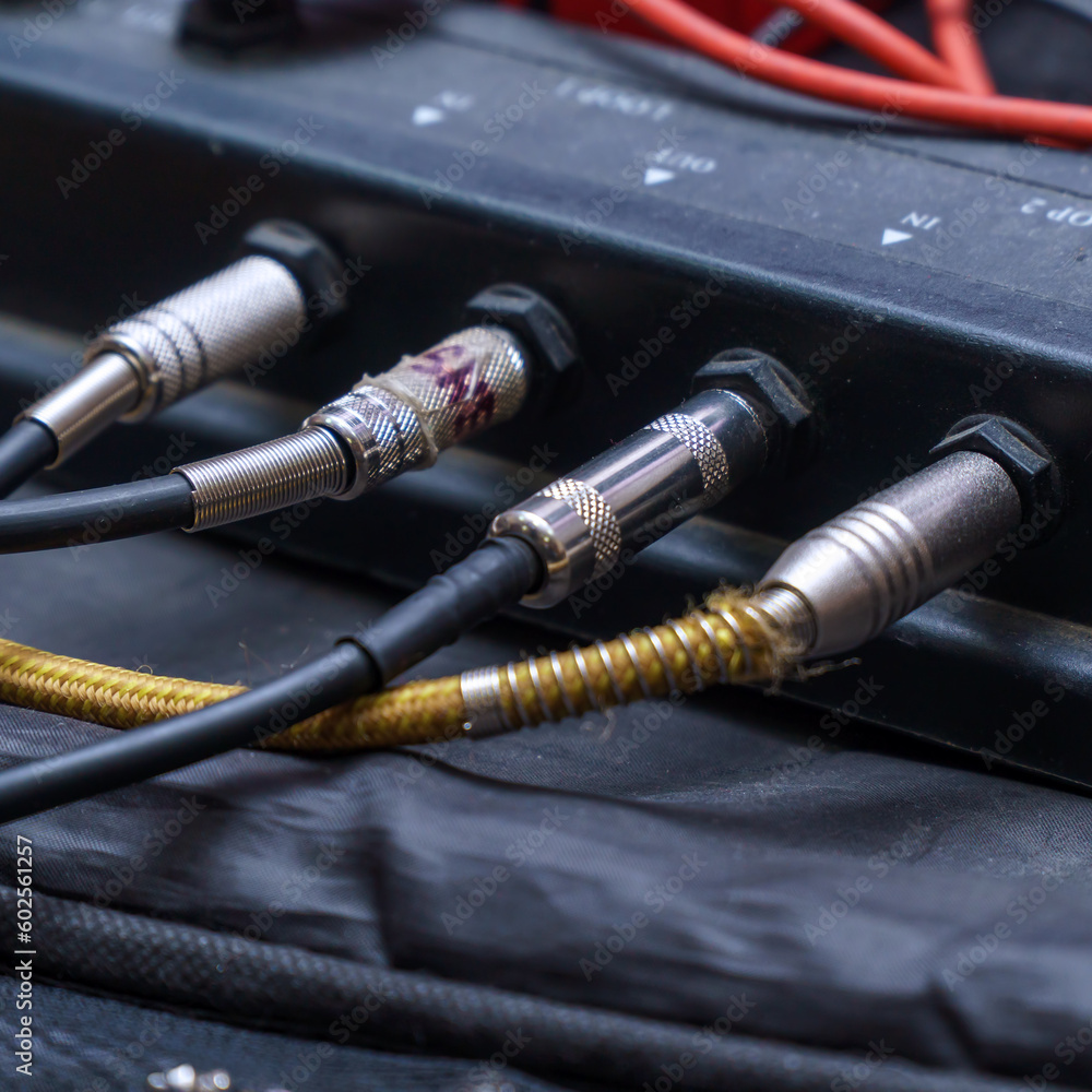 Audio jacks are plugged into a guitar synthesizer or processor Audio jacks are plugged into a guitar synthesizer or processor