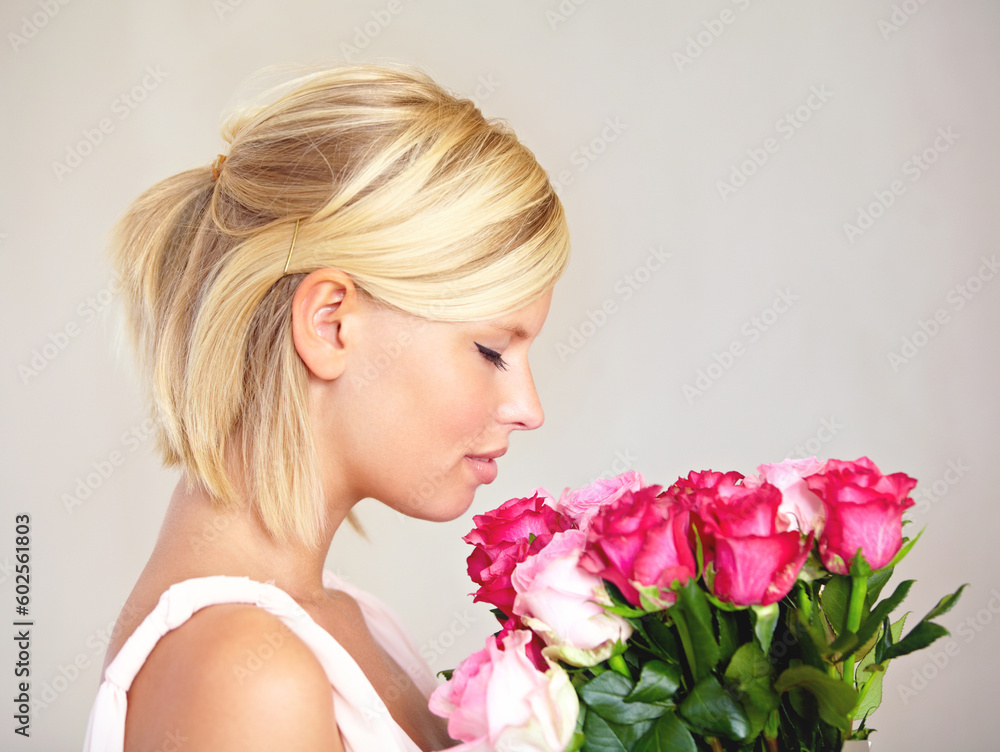 Smelling, side profile and woman with flowers as a gift isolated on a white studio background. Aroma scent, romantic and girl with a bouquet of roses for valentines day or anniversary on a backdrop
