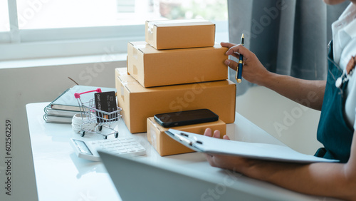 Asian business man seller freelancer prepares box for delivery to customer in sme supply chain, warehouse.