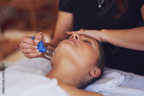 Woman having a face cupping massage in salon