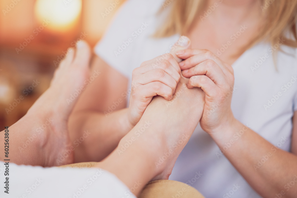 Woman having foot reflexology massage in salon Woman having foot reflexology massage in salon
