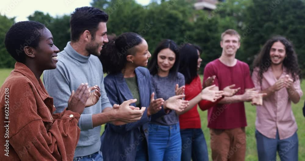 Group of young multiracial people clapping hands outdoor Group of young multiracial people clapping hands outdoor