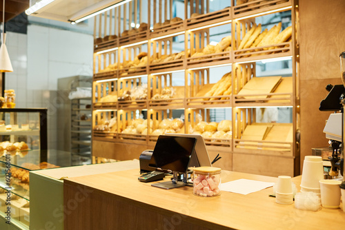 Fotobehang Workplace of baker or clerk of bakery shop or cafeteria with tablet, stacks of d