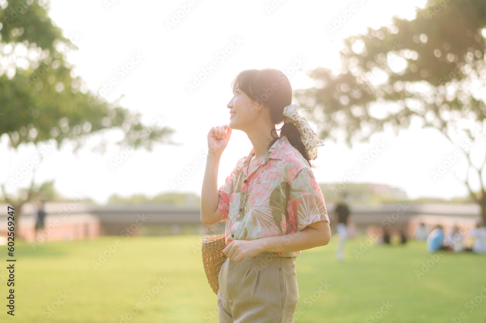 Portrait beautiful young asian woman on summer holiday vacation trip in Thailand. Young hipster female tourist sightseeing summer urban Bangkok destination. Asia summer tourism concept.