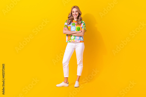 Full length photo of charming confident lady wear flower print t-shirt smiling arms crossed isolated yellow color background