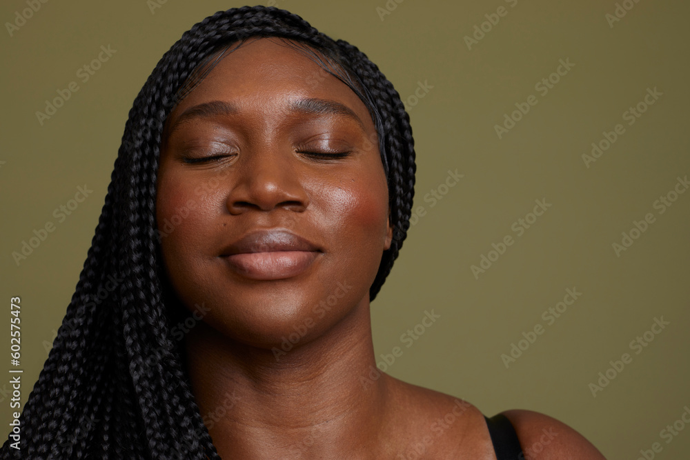 Portrait of woman with closed eyes against green background Portrait of woman with closed eyes against green background