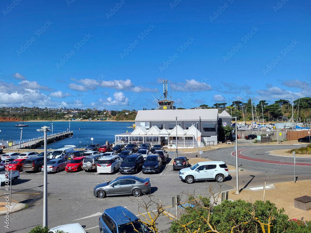 Car park at Mornington Pier in Port Phillip Bay. A popular tourist destination on the Mornington Peninsular. Cars park in the available spaces.