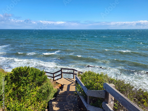 View from the boardwalk at Mornington overlooking Port Phillip Bay with rough seas and blue skies. photo