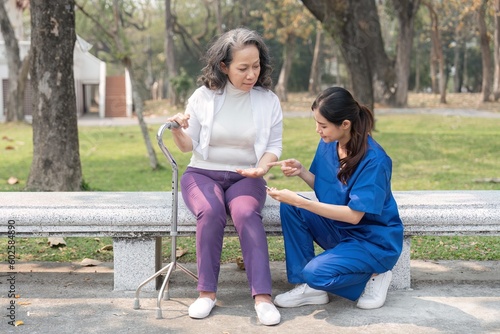 Nurse giving medicine to senior woman at hospital park, Maintenance