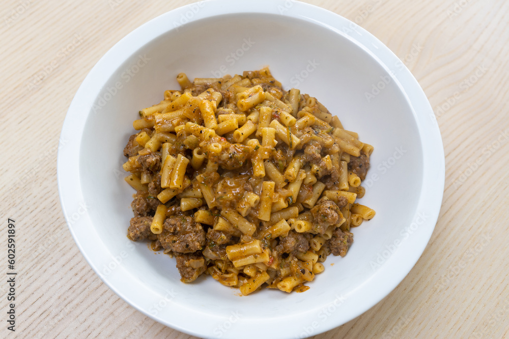 A bowl of macaroni and cheese with beef mince. A bowl of macaroni and cheese with beef mince.