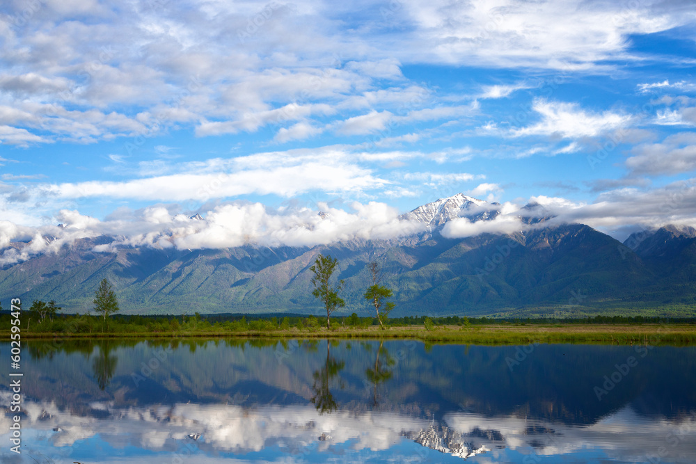 Russia. Landscape with mountains reflecting in the water on summer day. Buryatia, Tunkinskaya valley