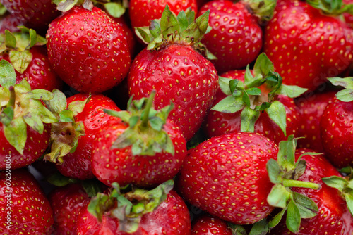 Red background of ripe strawberries. Close up, top view.