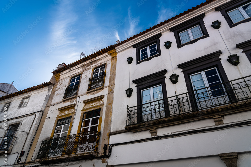 Naklejka premium Cityscape of Evora with typical houses painted in white and yellow. Alentejo, Portugal