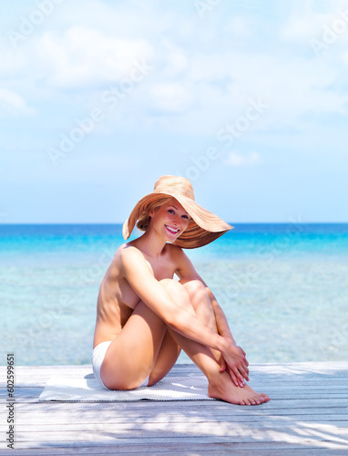 Travel, topless and portrait of woman at beach for sunbathing, summer break and freedom in Bali. Sexy, blue sky and tropical with girl in bikini on vacation for mockup, peace and happy on trip