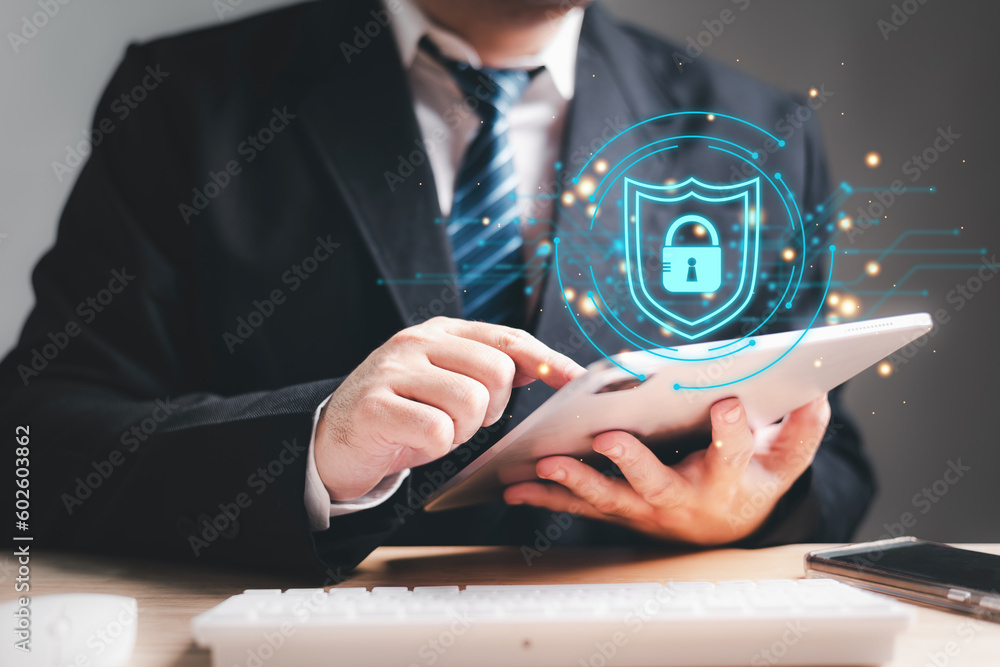 Businessman using tablet to access the cyber security guard software on desk. Data privacy protection and two factor authentication face recognition innovative technology concept - obrazy, fototapety, plakaty 