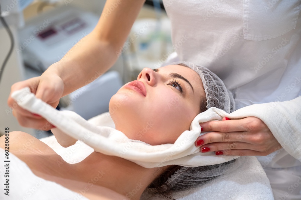 Beautiful young woman getting a face treatment at beauty salon. Beautiful young woman getting a face treatment at beauty salon.