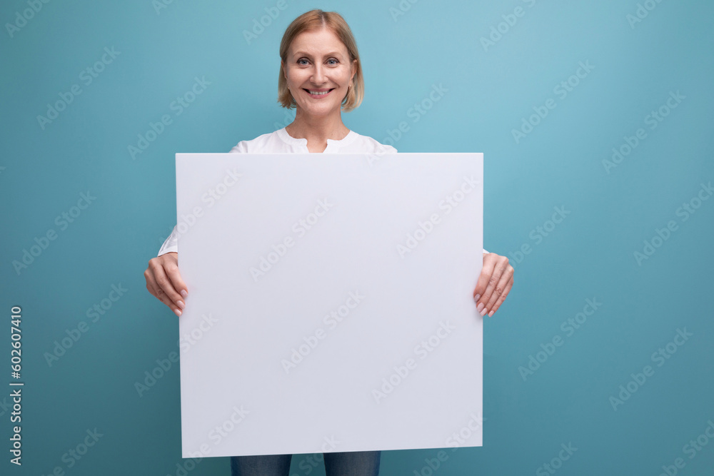 middle aged woman holding blank white paper for news with mocup middle aged woman holding blank white paper for news with mocup