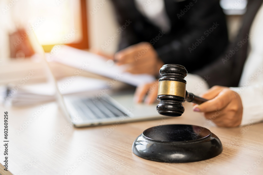 judge on wooden table And experienced lawyers meet with clients and give advice behind the scenes. legal services legal consulting concept judge on wooden table And experienced lawyers meet with clients and give advice behind the scenes. legal services legal consulting concept