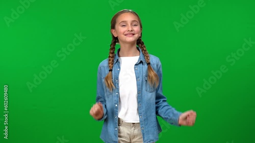 Front view teen girl gesturing pleasant smell smiling looking at camera on green screen. Positive satisfied Caucasian teenager posing on chroma key background smelling something good