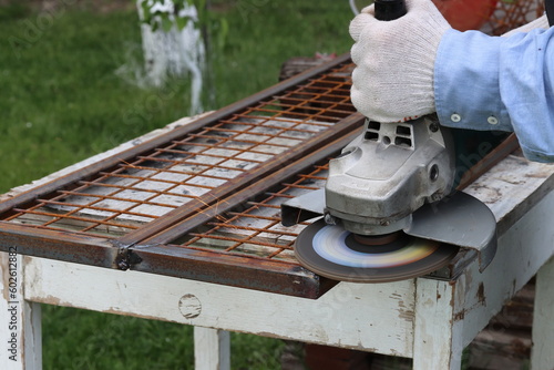 Cleaning metal in places of electric welding using a flap disc for an angle grinder photo