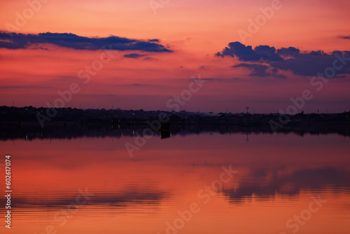 Romantic pink skies reflecting on a calm and serene lake