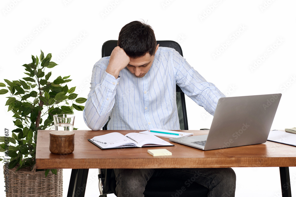 sad businessman using laptop, sitting on chair at desk sad businessman using laptop, sitting on chair at desk