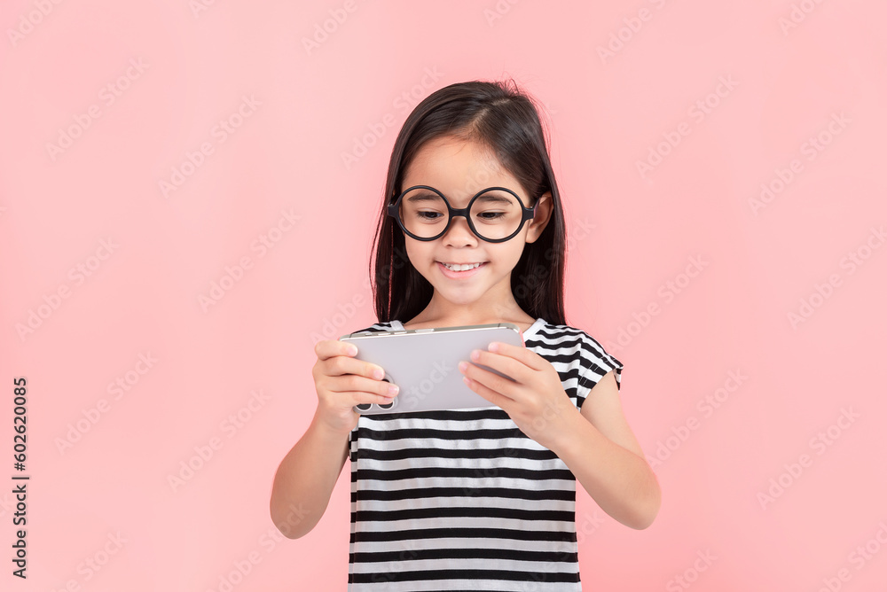 Little girl play phone mobile. Isolated on pink background Little girl play phone mobile. Isolated on pink background