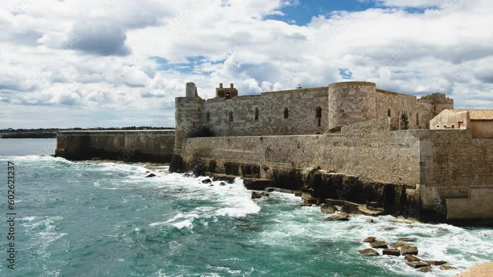 Castle of Meniace in Syracusa Ortigia Island on the sea waves Castle of Meniace in Syracusa Ortigia Island on the sea waves
