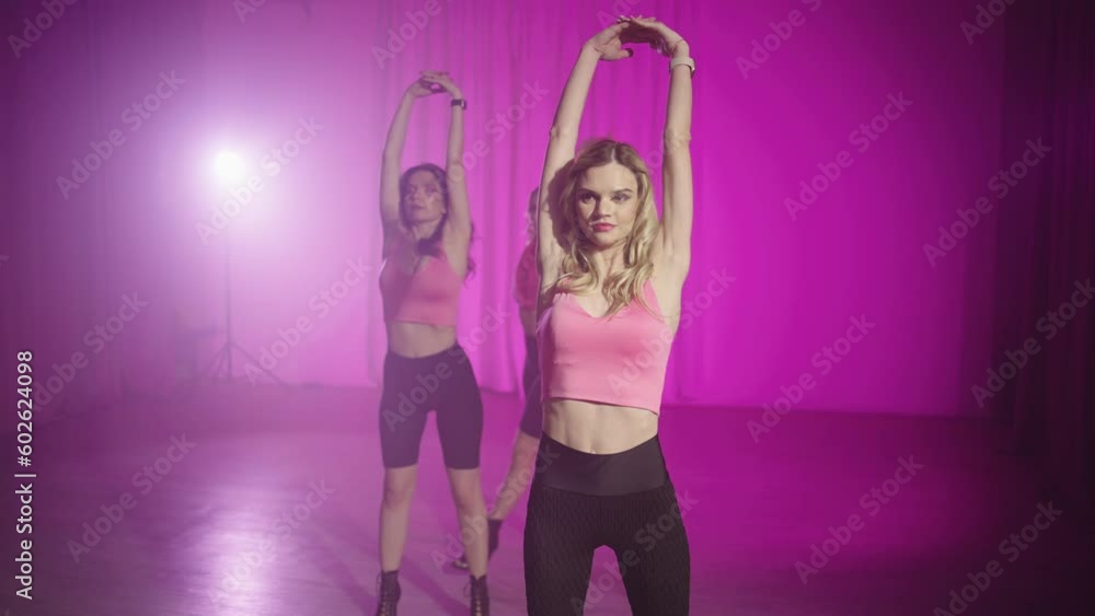 Group dance training with a coach. Beautiful Caucasian women doing choreography in the dance hall. Active lifestyle. High quality 4k footage Group dance training with a coach. Beautiful Caucasian women doing choreography in the dance hall. Active lifestyle. High quality 4k footage