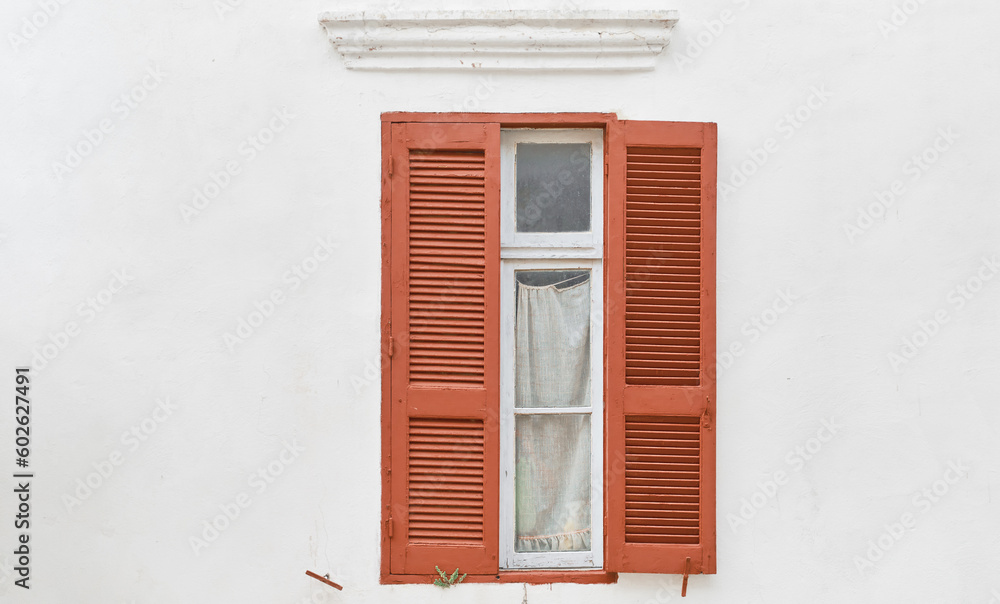 Fototapeta premium Wall of traditional greek house with wooden shutters, idea for background or article, city of Rhodes, travel to popular places of dodecanese archipelago Greece.