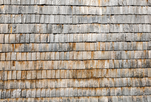 Wooden roof shingles on a wall as creative background