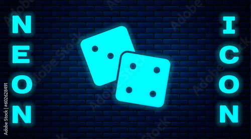 Glowing neon Game dice icon isolated on brick wall background. Casino gambling. Vector