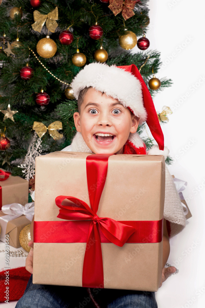 Baby next to the Christmas tree. Christmas Kids. Happy Children Opening Gifts. new year. Boy receiving Christmas gifts Baby next to the Christmas tree. Christmas Kids. Happy Children Opening Gifts. new year. Boy receiving Christmas gifts