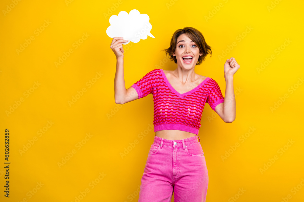 Photo of youngster funky girl wear pink crop top fist up hold bubble paper phrase finally decision speech idea isolated on yellow color background Photo of youngster funky girl wear pink crop top fist up hold bubble paper phrase finally decision speech idea isolated on yellow color background