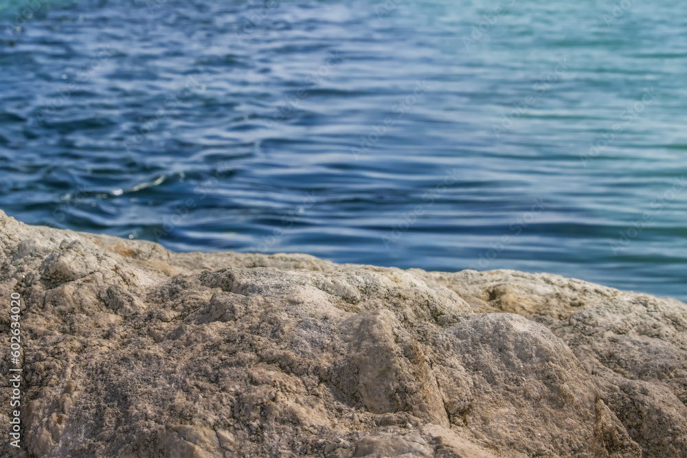 Stone texture in the foreground against the sea Stone texture in the foreground against the sea
