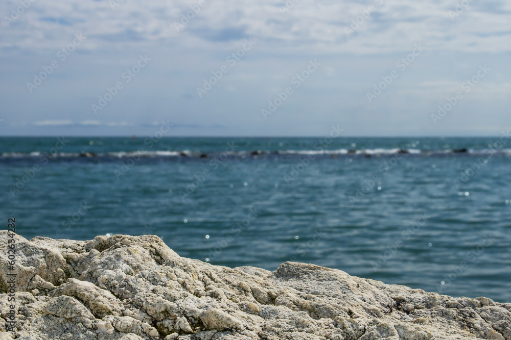 Stone texture in the foreground against the sea